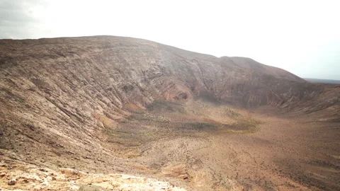 Walking inside volcanic crater on empty island Stock Footage 318797740