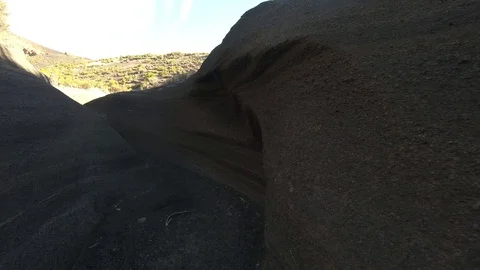 Walking inside volcano malacara grey debris, dry river of vocanic depositions Video stock 97189629