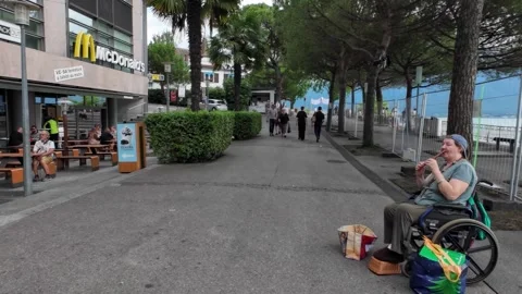 Walking Lakeside Promenade with Storefronts and Tourists Stock Footage 340367644