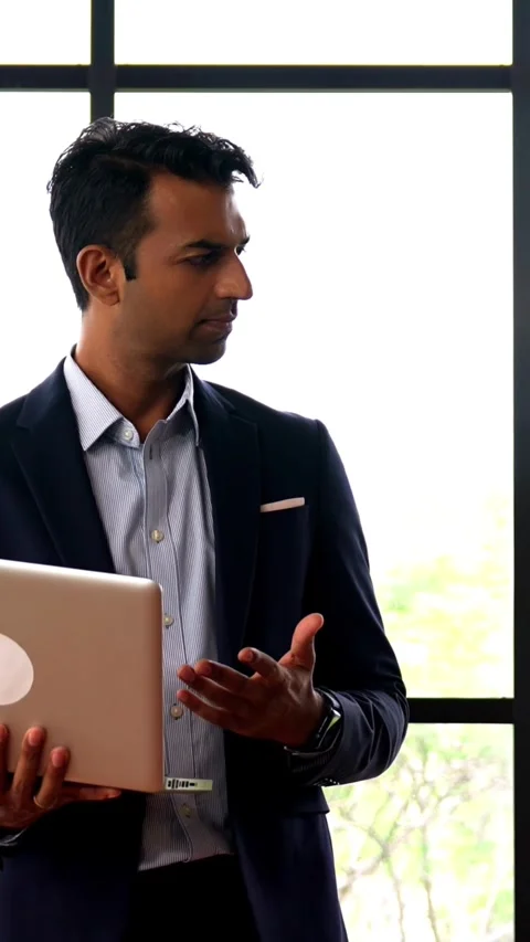 Walking with laptop inside office, Indian business professionals discuss project Stock Footage 342559772