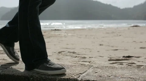 Walking on ledge on beach profile 스톡 동영상 55692920