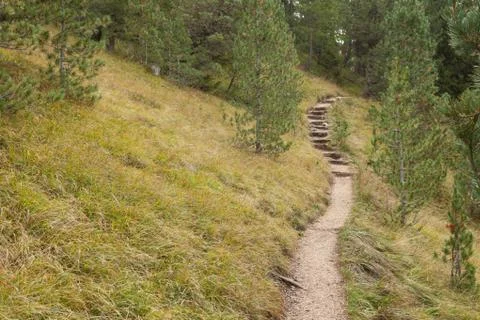 Walking long a mountain path in Valle di Funes into the Italian Dolomites Stock Photos