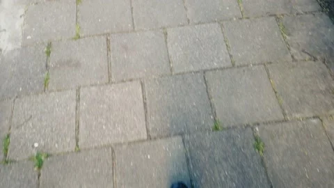 Walking looking down pavement foot 動画素材 130357149