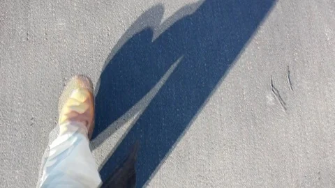 Walking man, on a background of asphalt. Stock Footage 111261120