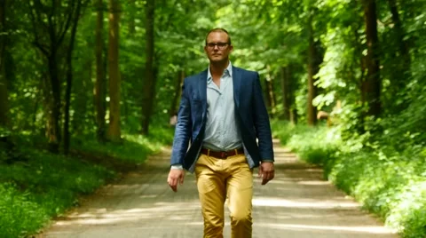 Walking man facing camera. single male person. walk outdoors. Stock Footage 64800940