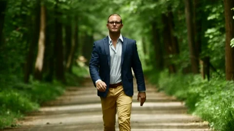 Walking man facing camera. slow motion. male person. single. alone. activity Stock Footage 64800967