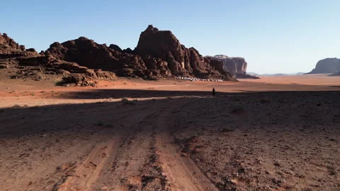 Walking in Marsian desert, bubble camp in background, Wadi Rum, Jordan - 06 Video stock 259375739