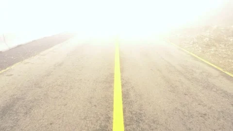 Walking in the middle of the road through a heavy fog 4k Stock Footage 162466978