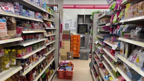 Walking motion inside 7 eleven store aisle, items for sale on shelf, Thailand Stock Footage 234647186