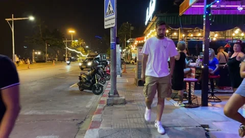 Walking motion on sidewalk with bars and clubs, nightlife, Pattaya, Thailand Video stock 234594737