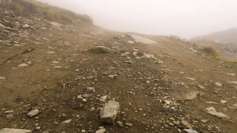 Walking on the mountain road through the fog 4k Stock Footage 162467016