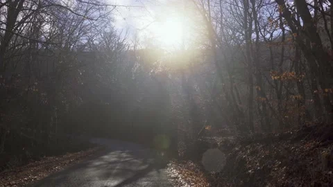Walking up a mountain in winter with a slight fog and the sun shining Stock Footage 168855571