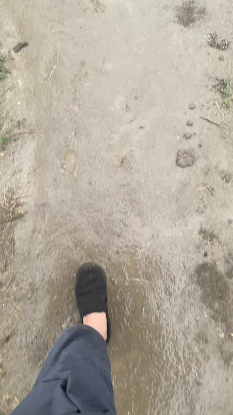 Walking on a mudy way in rain. Stock Footage 305166922