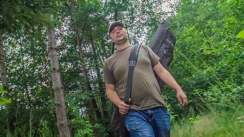 Walking on a narrow forest path to reach a lake Stock Footage 112175637