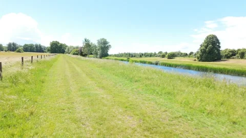 Walking next to the river nene on a summers day Stock Footage 339798984