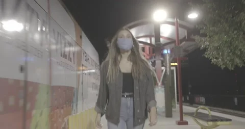 Walking next to train as it arrives with mask Stock-Footage 141478264