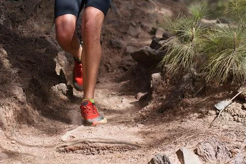 Walking or running exercise legs on rocky footpath Fotos de archivo