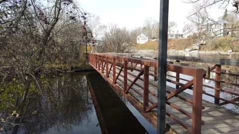 Walking over a river on a foot bridge Stock Footage 143197177