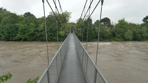 Walking over swollen river Stock Footage 130374730