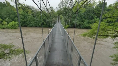 Walking over swollen river Stock Footage 130376484
