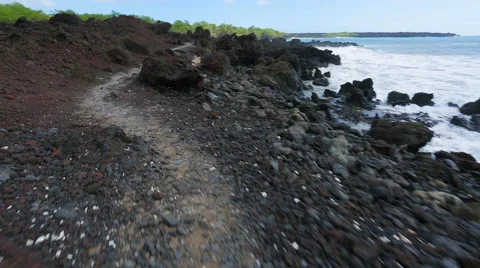 Walking over volcanic rock on winding shore in South Maui, Hawaii. Stock Footage 57225515