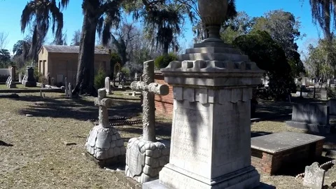 Walking past a cross grave stone in a Savannah cemetery Stock Footage 72906188