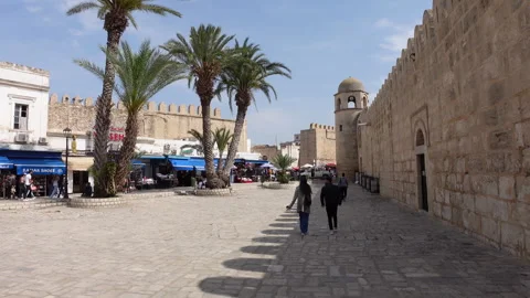 Walking past Great Mosque of Sousse towards market and bazaar in historic Medina Stock Footage 328632865