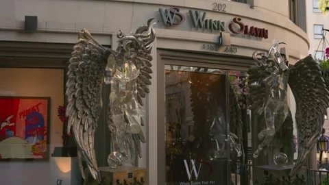 Walking past luxury storefronts Rodeo Drive Beverly Hills Los Angeles Stock Footage 332604542