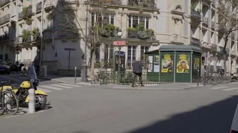 Walking past a Paris metro stop, exploring the urban environment with sunny Stock Footage 306654697