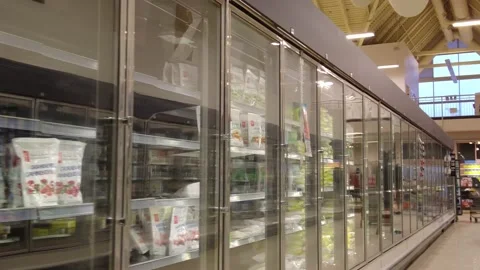 Walking Past Partially Empty Grocery Freezers Then Revealing Two Men Wearing Stock Footage 222421565