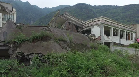 Walking past remains of collapsed school building, Wenchuan earthquake memorial Stock Footage 67549426