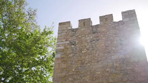 Walking past a restored castle wall tower Stock Footage 273675790