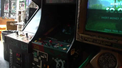 Walking Past Retro Arcade Games in Grungy Graffitied Restaurant 库存影片 166815500