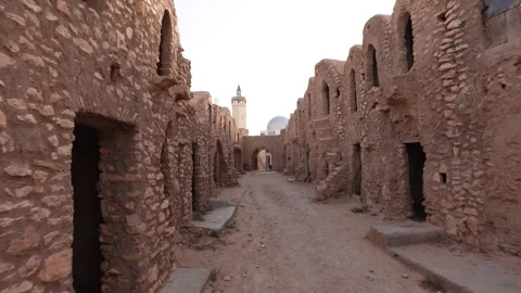 Walking past ruins of Ksar Hadada town in Tunisia Stock Footage 345034011