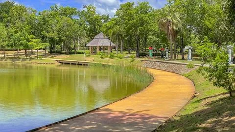 A walking path along the lake at King Rama IX Park, Phuket Stock Photos