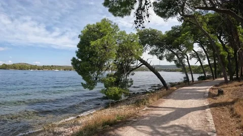 Walking path on the coast of the canal of St. Ante near Sibenik in Croatia Stock Footage 227393704