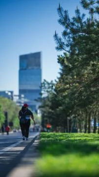 Walking path with green trees and modern cityscape in Almaty, Kazakhstan Stock Photos