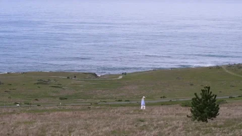 Walking on a path by the ocean waves Stockbeeldmateriaal 153950396