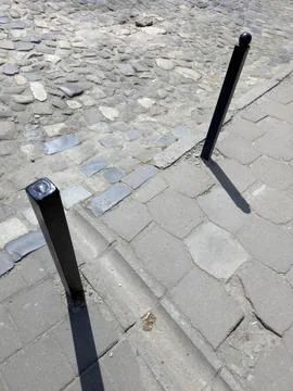 Walking Path With Stones and Black Posts Located in a City Area on a Sunny Da Stock Photos