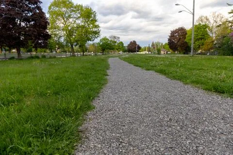 Walking path through green grassy park in Smiths Falls, Ontario, Canada. Long Stock Photos