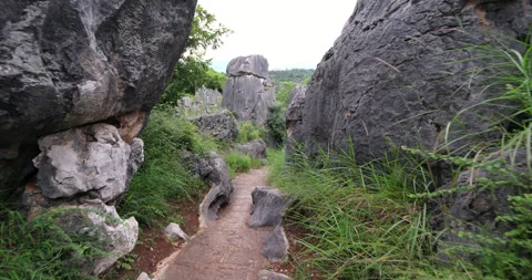 Walking a path through Shilin Stone Forest in Kunming, China Stock Footage 329492486