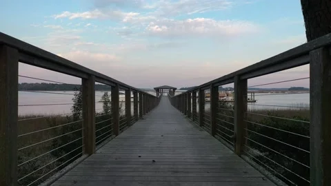Walking path towards the lake. Lake, boat, sky and clouds. Stock Footage 153801074