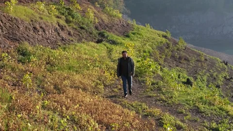 Walking path, young man walking the path by the lake Stock Footage 166550299