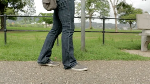 Walking on paved path grass in bg 스톡 동영상 55693119