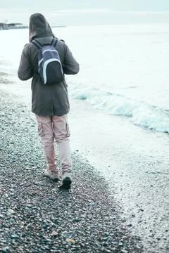 Walking on pebble coast Stock Photos