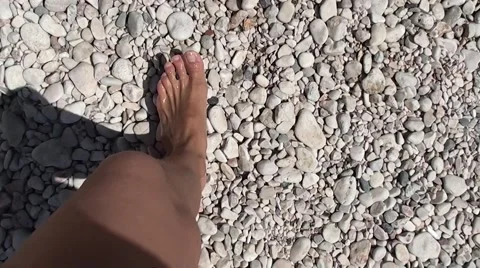 Walking on pebbles at the beach top view Stock Footage 51173941
