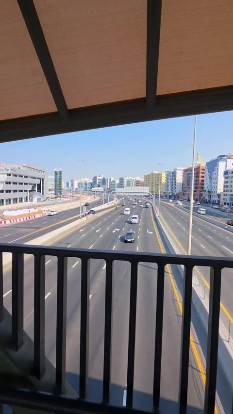 Walking on the pedestrian bridge over Al Mina Street in Dubai, UAE Stock Footage 327388346