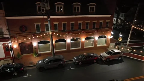 Walking pedestrian on sidewalk in decoded American town at night. Christmas Video stock 303880693