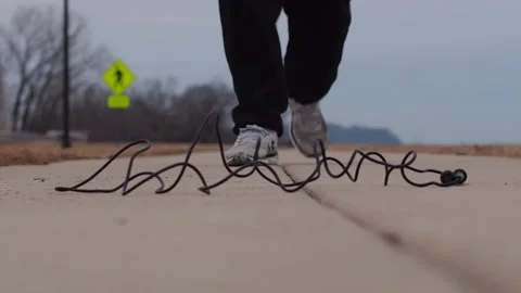 Walking to pick up jump rope low shot front Stock Footage 231413270