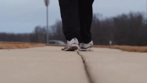 Walking to pick up jump rope low shot back Stock Footage 231413272